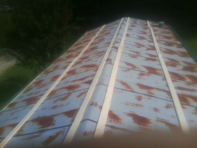 Rusted metal roof panels with new wood purlins before replacement — Storm Damage Roof Repair in Horatio by Roofing Brothers